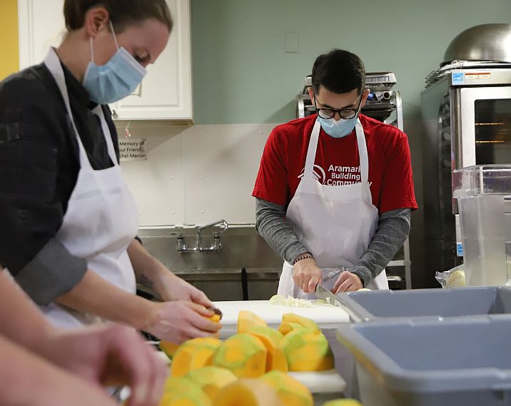 employee volunteers working in a community food center